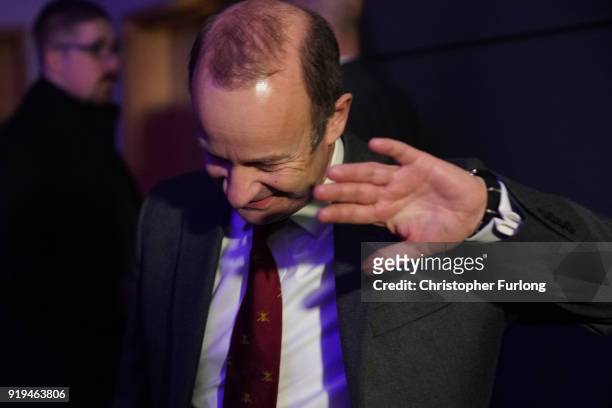 Former UKIP leader Henry Bolton covers his face to shield from photographers flashes after losing the leadership of the party on February 17, 2018 in...