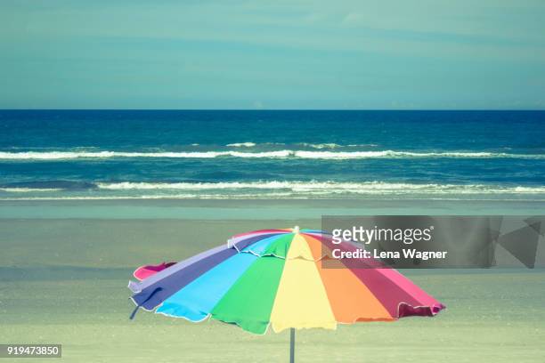 multi-colored parasol against beach scenery - ニュースムーナ・ビーチ ストックフォトと画像