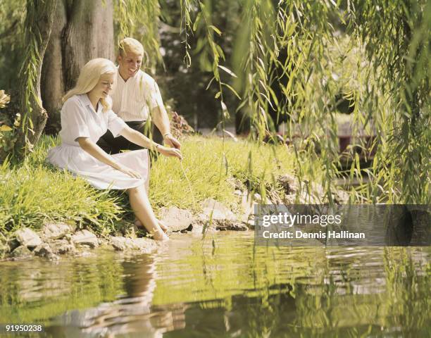 Romantic couple sitting by lagoon