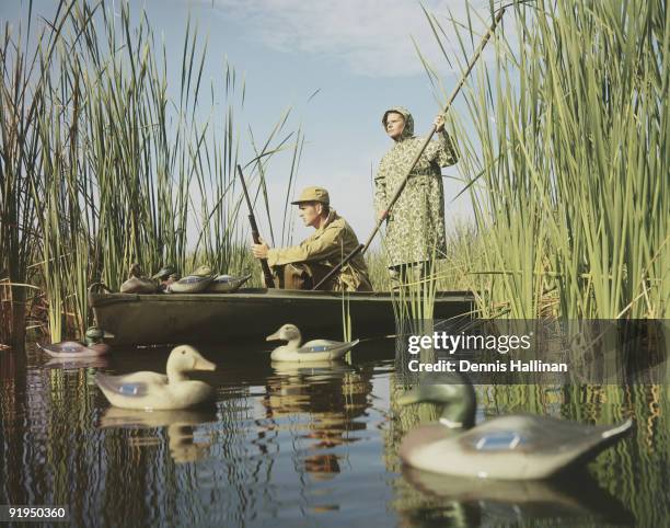 Two men duck hunting with decoys