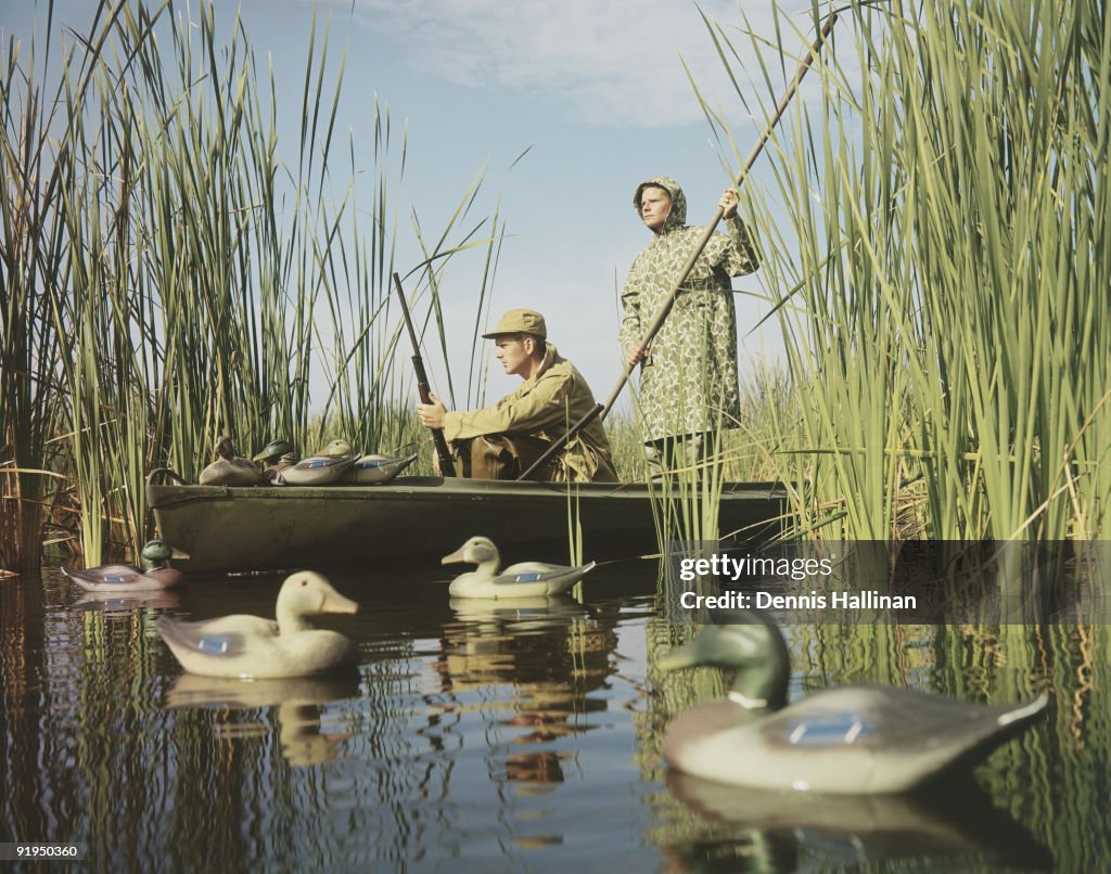 Two men duck hunting with decoys