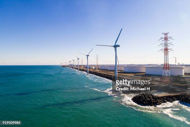 windmills by the sea - eco system stockfoto's en -beelden