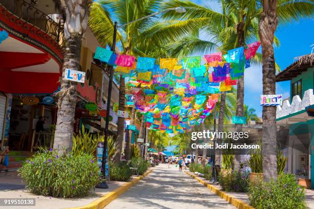 colorful flags over street in village of sayulita, mexico - nayarit stock pictures, royalty-free photos & images