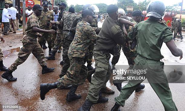 Guinean police arrest a protester on September 28, 2009 in front of the biggest stadium in the capital Conakry during a protest banned by Guinea's...