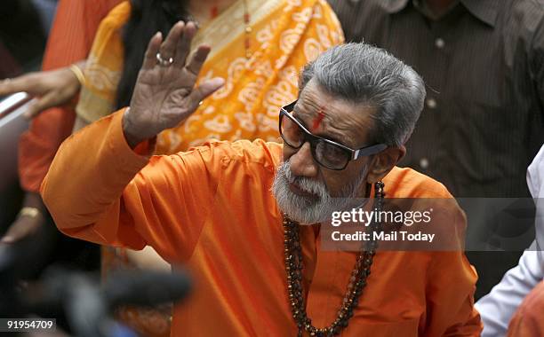 Bal Thackeray, chief of the right wing Hindu party Shiv Sena, waves towards the media as he arrives to cast his vote at a polling centre during the...