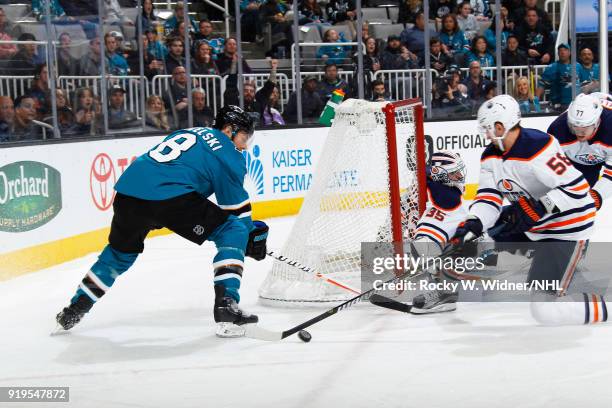 Anton Slepyshev of the Edmonton Oilers defends the net against Joe Pavelski of the San Jose Sharks at SAP Center on February 10, 2018 in San Jose,...