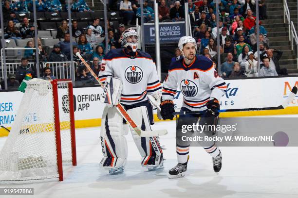 Al Montoya and Kris Russell of the Edmonton Oilers defend the net against the San Jose Sharks at SAP Center on February 10, 2018 in San Jose,...