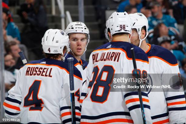 Connor McDavid, Kris Russell and Jesse Puljujarvi of the Edmonton Oilers huddle up during the game against the San Jose Sharks at SAP Center on...