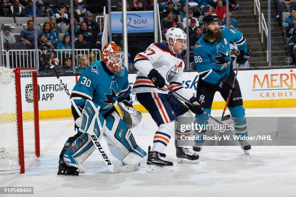 Aaron Dell and Brent Burns of the San Jose Sharks defend the net against Milan Lucic of the Edmonton Oilers at SAP Center on February 10, 2018 in San...