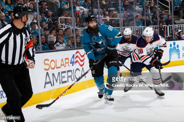 Brent Burns of the San Jose Sharks skates with the puck against Ryan Strome of the Edmonton Oilers at SAP Center on February 10, 2018 in San Jose,...