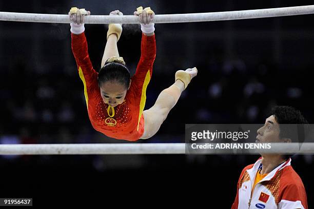 China's Deng Linlin performs in the uneven bars event in the women's individual all-around final during the Artistic Gymnastics World Championships...