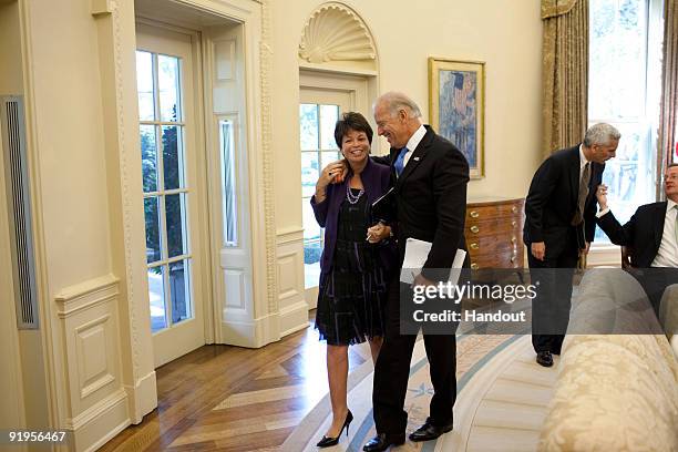 In this handout photo provided by the White House, Vice President Joe Biden and Senior Advisor Valerie Jarrett talk as they leave the Economic Daily...