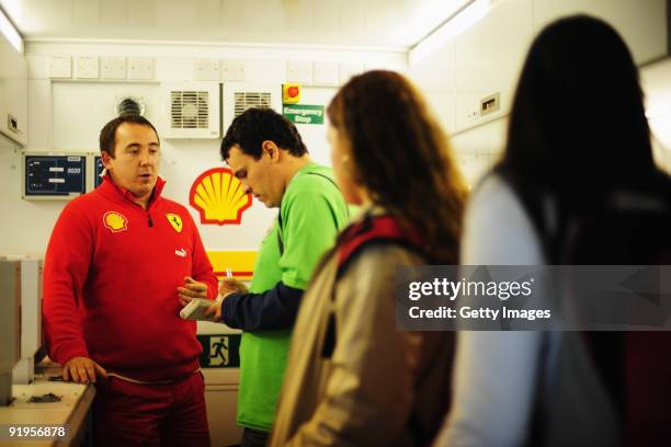 Gareth Lowe of Shell shows guests around the Shell Track Lab during practice for the Brazilian Formula One Grand Prix at the Interlagos Circuit on...