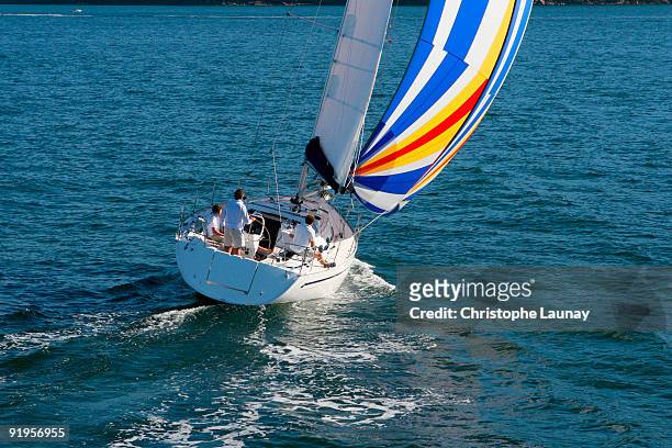aerial view of a sailing yacht with a colorful spinnaker cruising in pittwater on the north shore fr - pittwater stock pictures, royalty-free photos & images