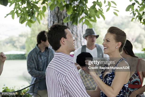 Actress Hilary Swank poses with John Campisi during a photo shoot on August 6, 2009 in Italy. Hilary Swank's wardrobe provided by Louis Vuitton, hair...