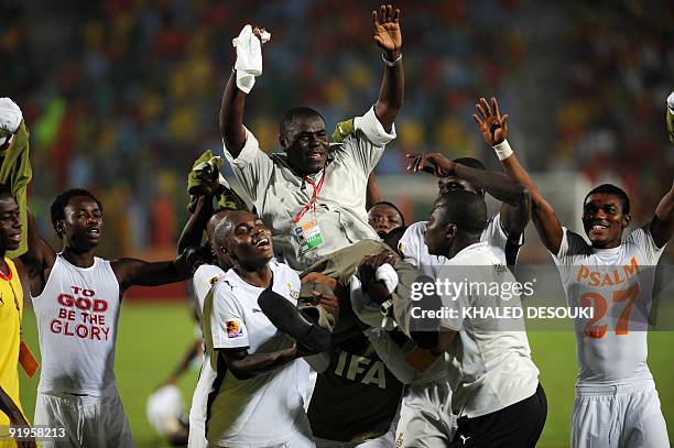 Ghana's players carry their head coach Sellas Tetteh as they celebrate winning the FIFA U-20 World Cup in Cairo on October 16, 2009. Ghana overcame...