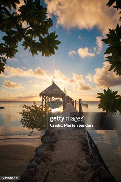 boardwalk towards boatramp and pearlfarm during sunset - merten snijders stock pictures, royalty-free photos & images