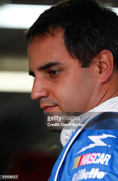 Juan Pablo Montoya, driver of the Lysol Chevrolet, stands in the garage during practice for the NASCAR Sprint Cup Series NASCAR Banking 500 at Lowe's...