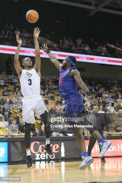 Davis of the UCF Knights shoots over the hand of Ben Emelogu II of the Southern Methodist Mustangs during a NCAA basketball game at the CFE Arena on...