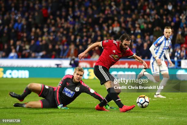 Juan Mata of Manchester United rounds Jonas Lossl of Huddersfield Town and puts the ball in the net before it is subsequently ruled out by the VAR...