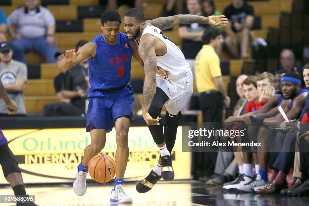 William Douglas of the Southern Methodist Mustangs fouls Dayon Griffin of the UCF Knights during a NCAA basketball game at the CFE Arena on February...