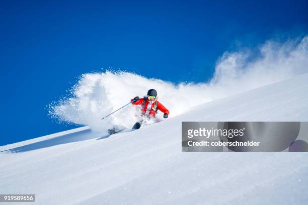 woman powder skiing in the alps, sportgastein, salzburg, austria - female skier stockfoto's en -beelden