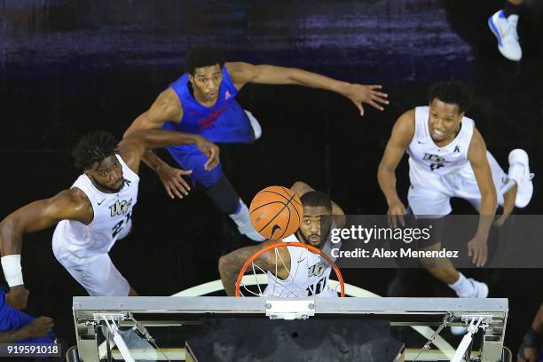 Dayon Griffin, Chad Brown Terrell Allen of the UCF Knights watch the ball as they attempt an offensive rebound during a NCAA basketball game against...