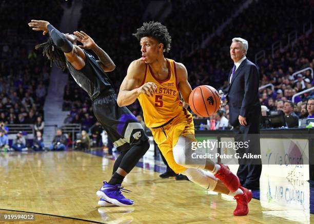 Lindell Wigginton of the Iowa State Cyclones drives around Cartier Diarra of the Kansas State Wildcats during the first half on February 17, 2018 at...