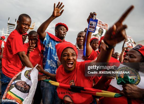 Zimbabwe opposition party supporters cry, react and chant as they hold placards picturing late Zimbabwe opposition leader Morgan Tsvangirai during a...