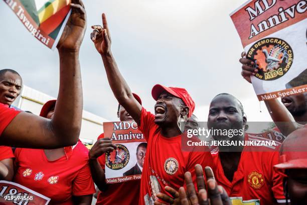 Zimbabwe opposition party supporters cry, react and chant as they hold placards picturing late Zimbabwe opposition leader Morgan Tsvangirai during a...