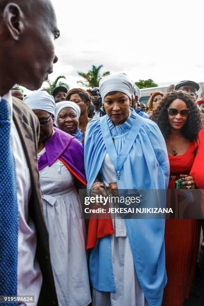 Zimbabwe opposition leader Morgan Tsvangirai's widow Elizabeth Tsvangirai makes her way through a crowd as she goes towards a cargo handling area...