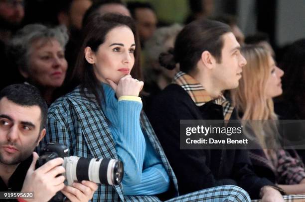 Michelle Dockery, James Righton and Sienna Miller wearing Burberry at the Burberry February 2018 show during London Fashion Week at Dimco Buildings...