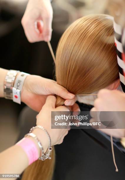 Model backstage ahead of the House of Holland show during London Fashion Week February 2018 at TopShop Show Space on February 17, 2018 in London,...