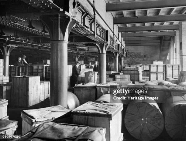 London and North West Railway Company goods shed, Sussex Street, Leicester, Leicestershire, 1927. Men moving a crate of produce in the Carmichael's...