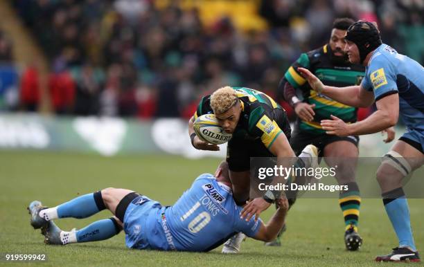 Luther Burrell of Northampton is tackled by Greig Tonks during the Aviva Premiership match between Northampton Saints and London Irish at Franklin's...