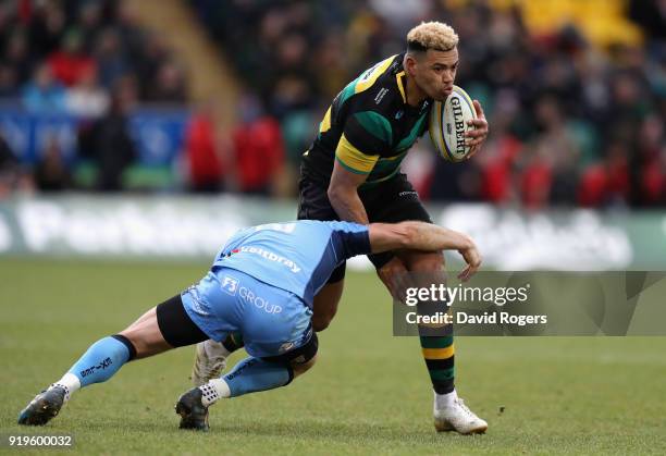 Luther Burrell of Northampton is tackled by Greig Tonks during the Aviva Premiership match between Northampton Saints and London Irish at Franklin's...