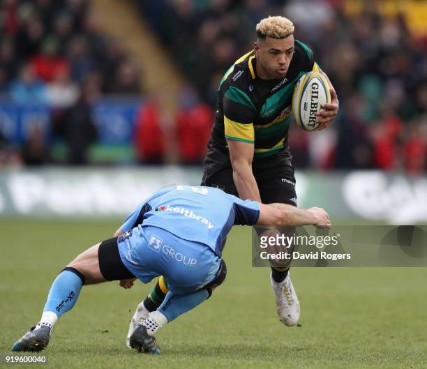 Luther Burrell of Northampton is tackled by Greig Tonks during the Aviva Premiership match between Northampton Saints and London Irish at Franklin's...