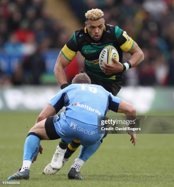 Luther Burrell of Northampton is tackled by Greig Tonks during the Aviva Premiership match between Northampton Saints and London Irish at Franklin's...