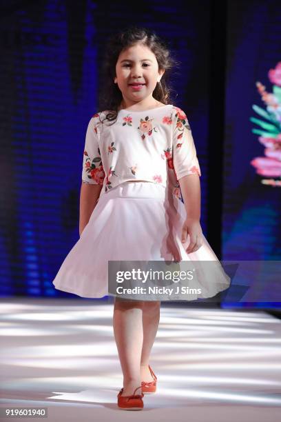 Models walk the runway for Camellia Couture at the House of iKons show during London Fashion Week February 2018 at Millenium Gloucester London Hotel...