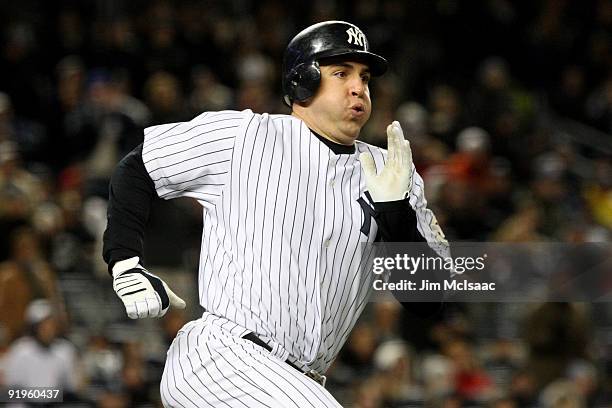 Mark Teixeira of the New York Yankees runs out a single in the third inning against the Los Angeles Angels of Anaheim in Game One of the ALCS during...