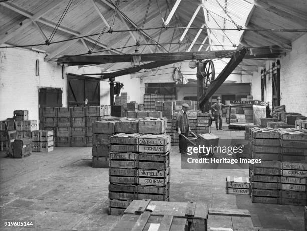 Goods shed, West Lancashire Station, Fishergate Hill, Preston, Lancashire, 1927. The interior of the Cantrell and Cochrane depot with an employee...