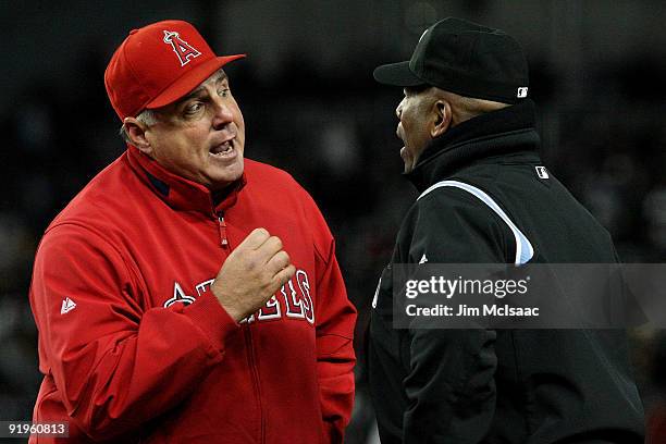 Mike Scioscia, Manager of the Los Angeles Angels of Anaheim argues with first base umpire Laz Diaz during Game One of the ALCS against the New York...