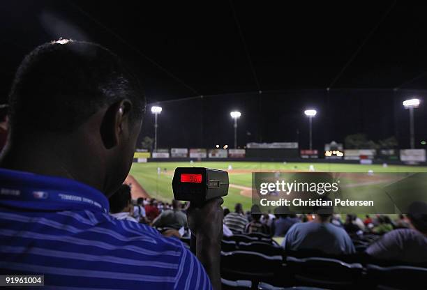 Scout uses a speed gun to track Washington Nationals prospect Stephen Strasburg, playing for the Phoenix Desert Dogs, during the Arizona Fall League...