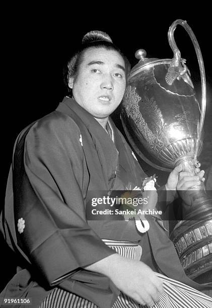 Sumo grand champion Kashiwado celebrates his win with the trophy of Autumn Grand Sumo Tournament on September 22, 1963 in Tokyo, Japan.