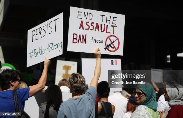 People join together after a school shooting that killed 17 to protest against guns on the steps of the Broward County Federal courthouse on February...