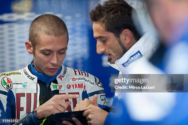 Valentino Rossi of Italy and Fiat Yamaha Team speaks with mechanich in box during the second free practice session of the 2009 MotoGP of Australia at...