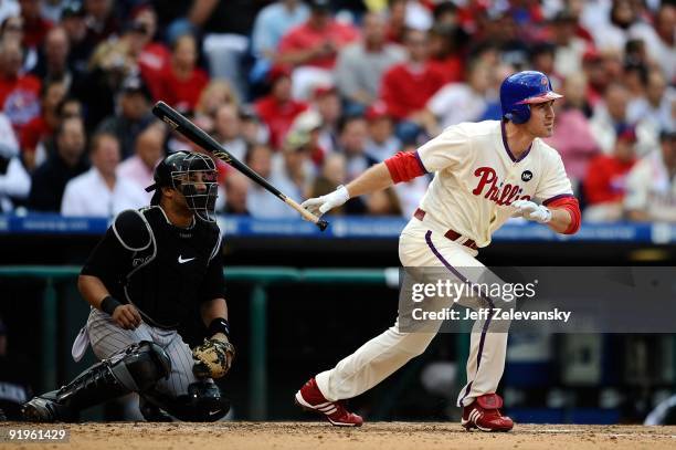 Chase Utley of the Philadelphia Phillies hits a single in the bottom of the sixth inning against the Colorado Rockies in Game One of the NLDS during...