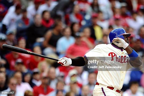 Ryan Howard of the Philadelphia Phillies hits a RBI double to drive in Chase Utley in the bottom of the sixth inning against the Colorado Rockies in...