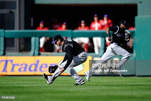 Brad Hawpe of the Colorado Rockies comits an error which allows Carlos Ruiz of the Philadelphia Phillies to advance to secodn on his RBI single in...