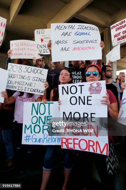 Protesters hold signs at a rally for gun control at the Broward County Federal Courthouse in Fort Lauderdale, Florida on February 17, 2018. Seventeen...